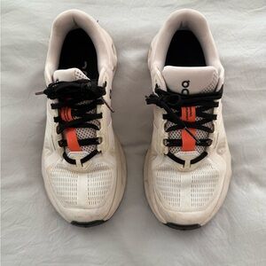 On Running White and Black Athletic Shoes